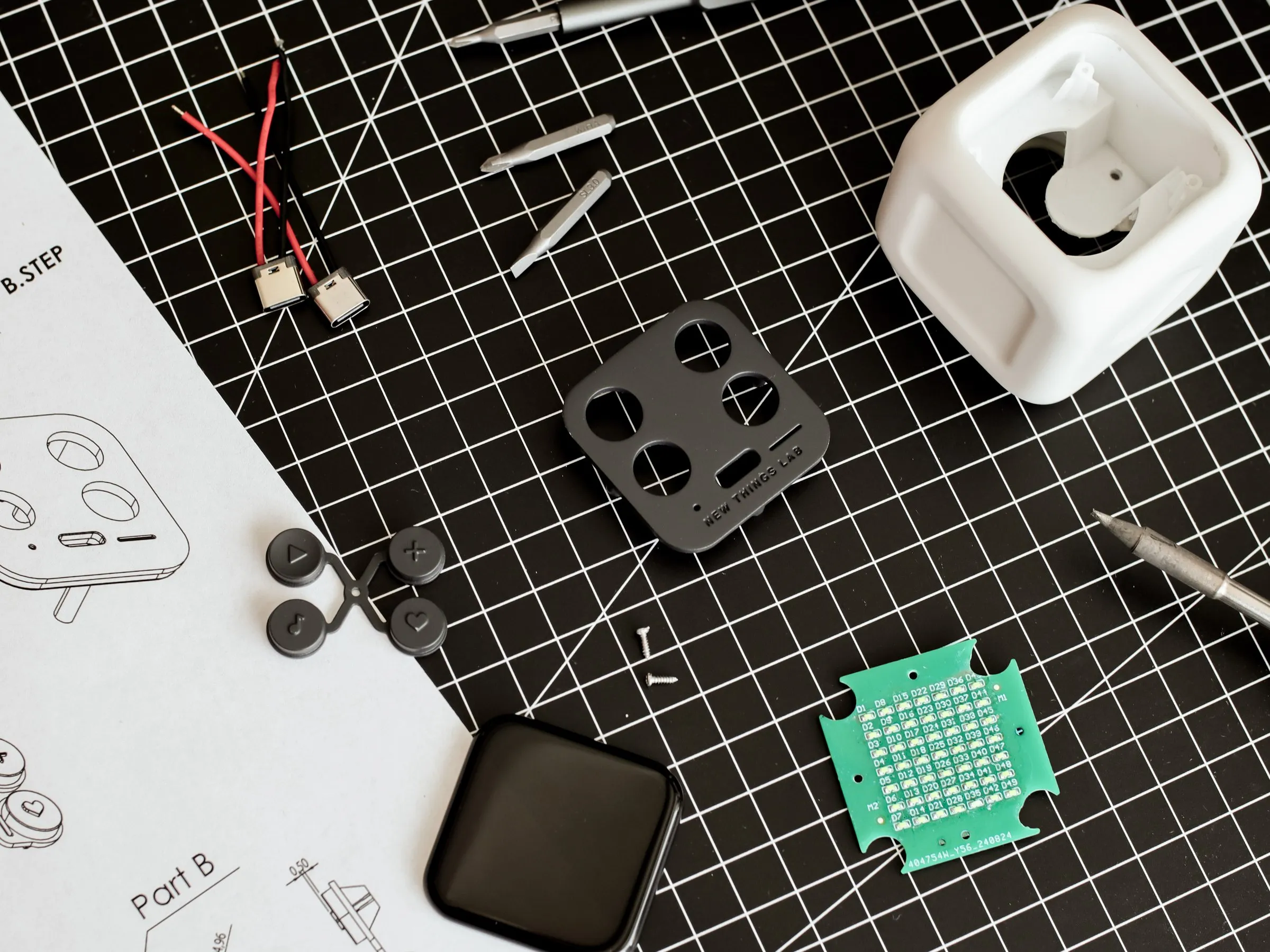 Prototype parts next to the drawings