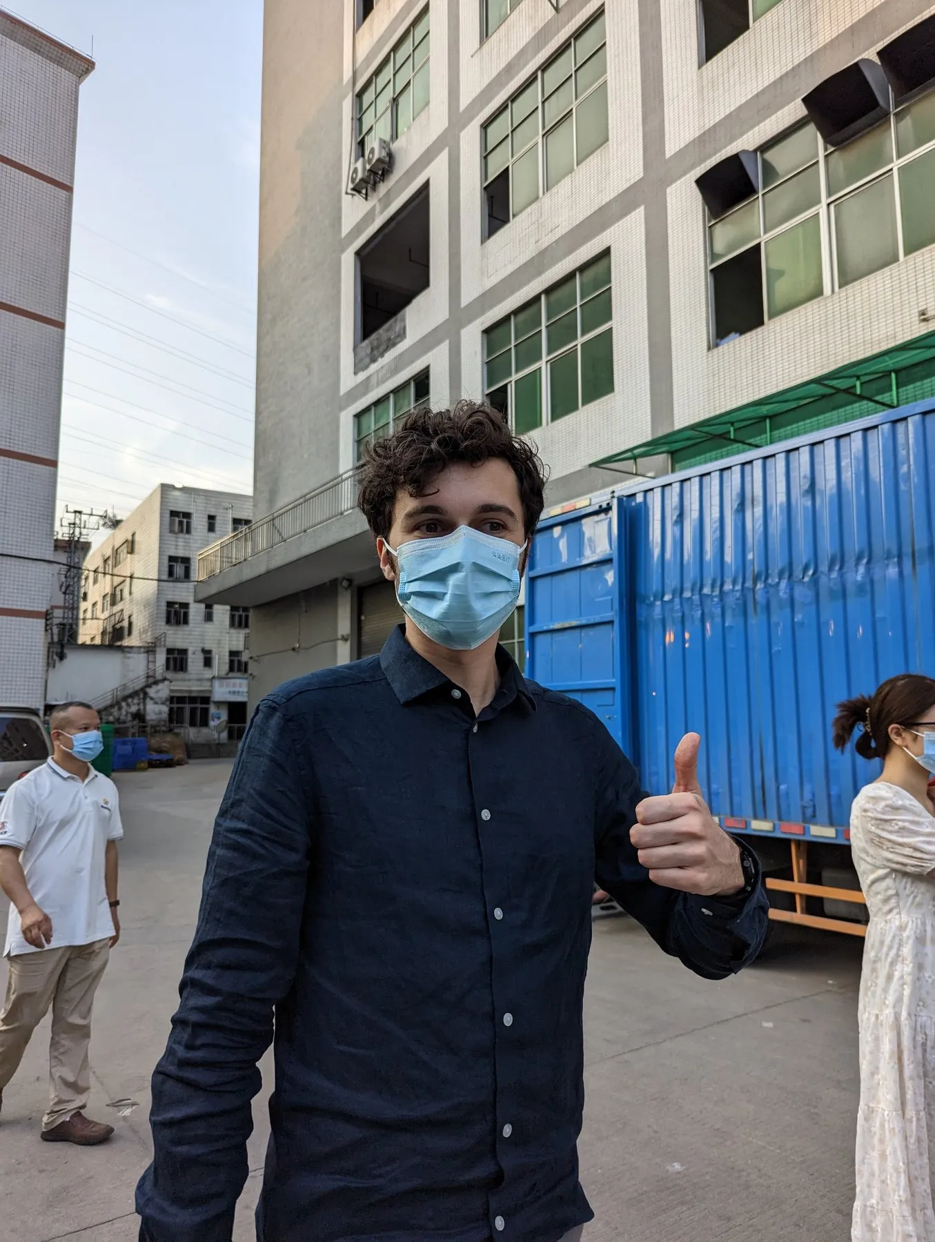 Thumbs up outside a factory in Shenzhen