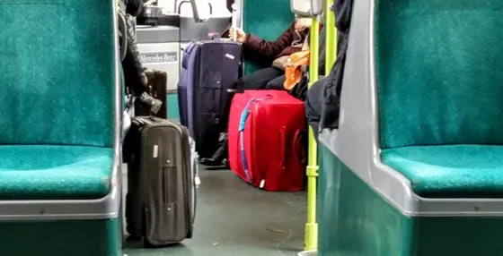 Suitcases in the aisle of an airport express bus